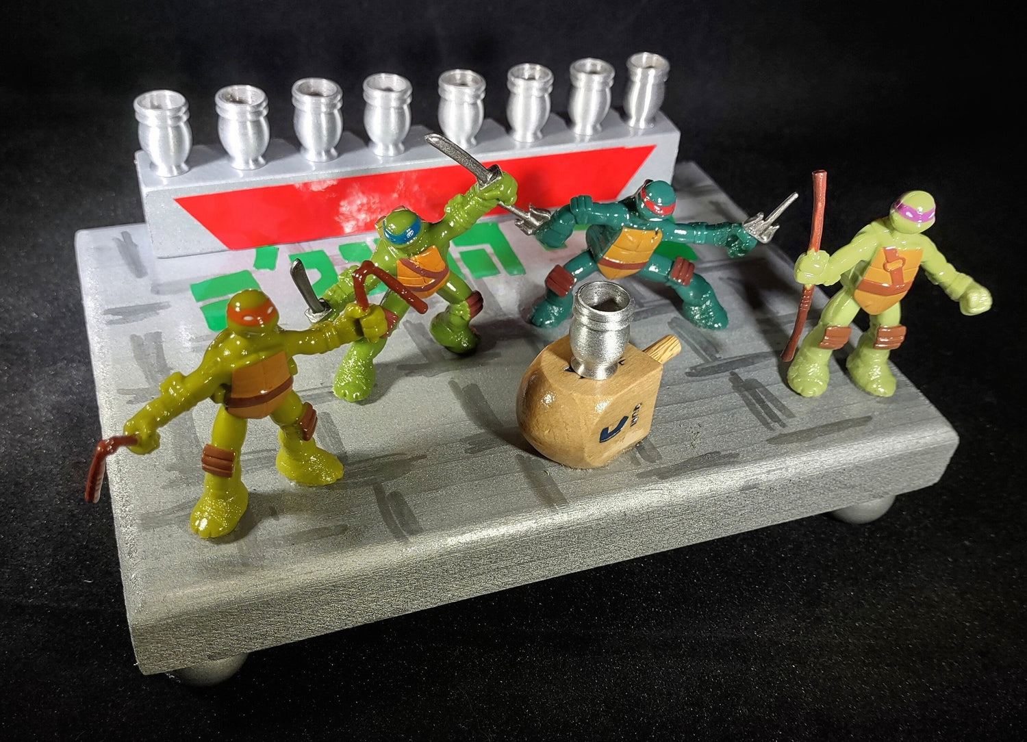 TMNT Menorah — four ninja turtle figures with Hebrew lettering and aluminum cups | Judaica Square Lakewood (view 2)