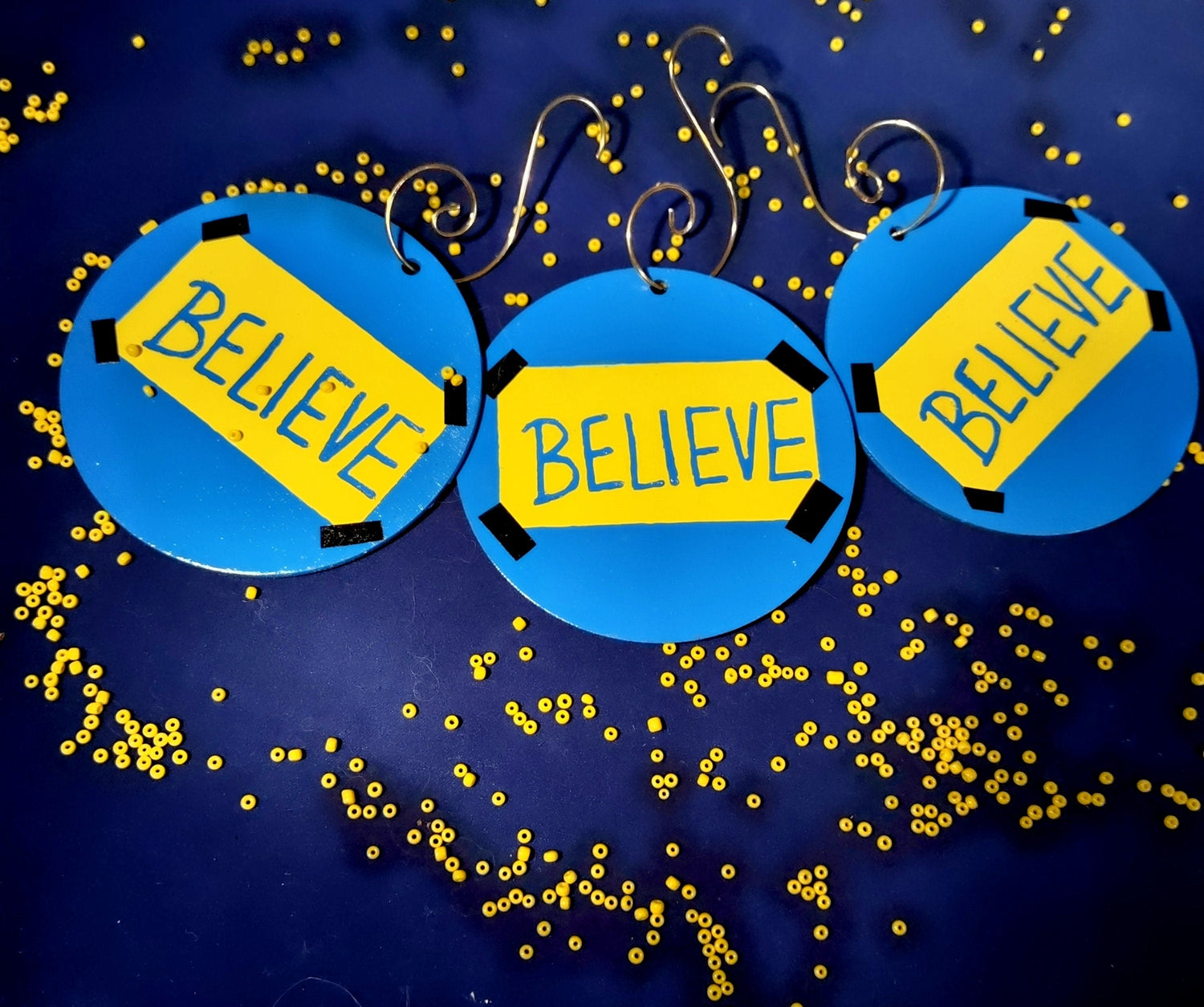 Believe ornament — Ted Lasso wood circle with vinyl lettering and gold spiral hook | Judaica Square Lakewood (view 3)