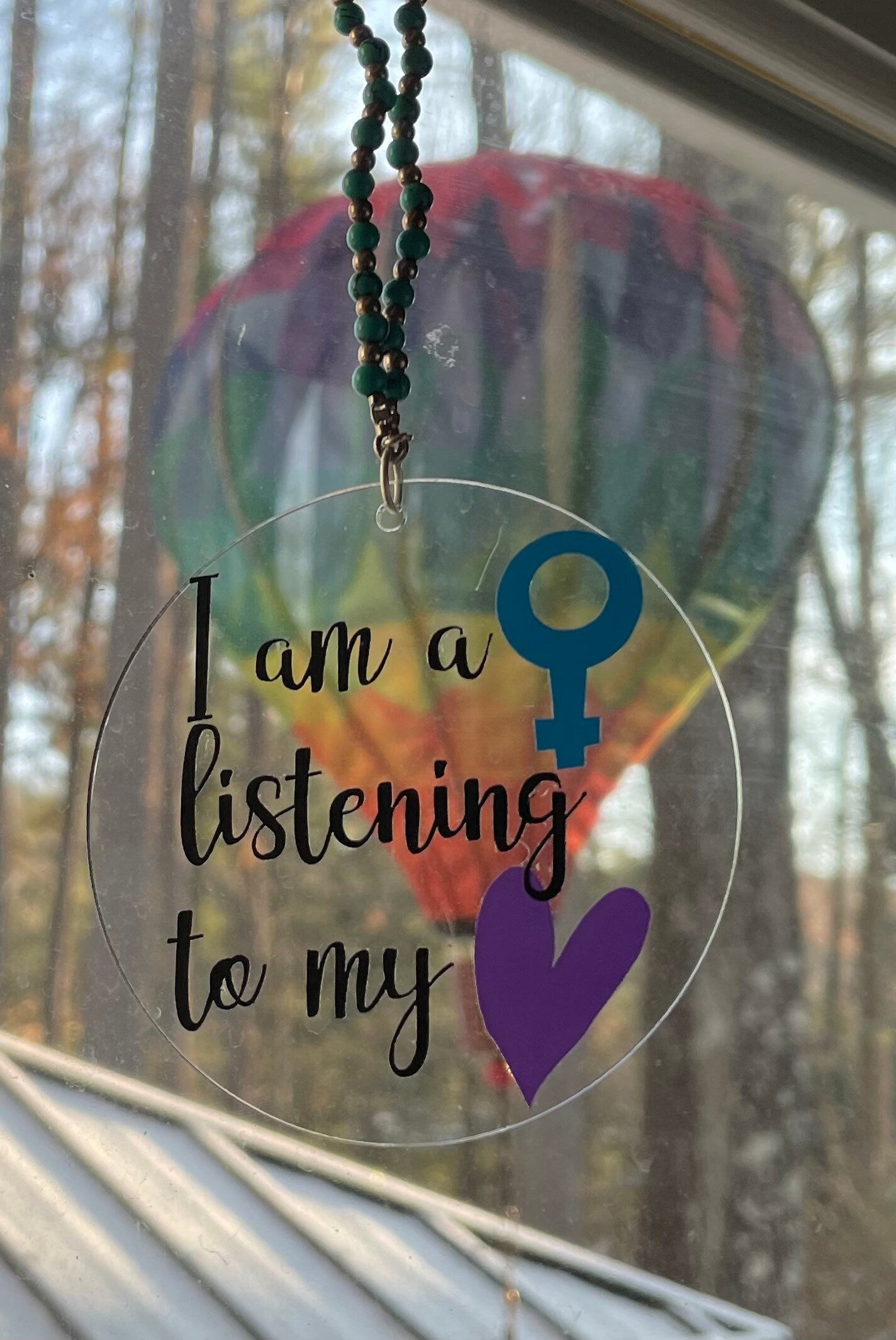 Feminist ornament reading Nevertheless She Persisted in painted wood | Judaica Square Lakewood (view 3)