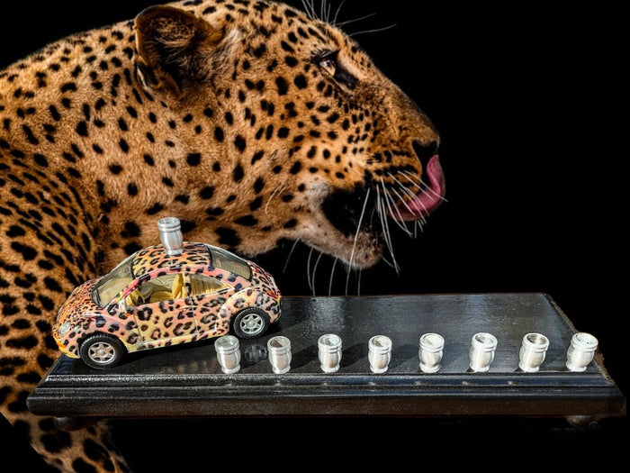 Punch-buggy menorah — leopard-print die-cast VW beetle on a painted wood base with candle cups | Judaica Square Lakewood