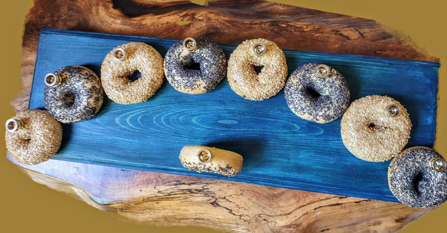Bagel Lover's Menorah — nine real shellacked bagels on a long stained wood base | Judaica Square Lakewood (view 2)