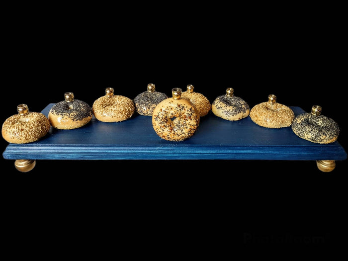 Bagel Lover's Menorah — nine real shellacked bagels on a long stained wood base | Judaica Square Lakewood