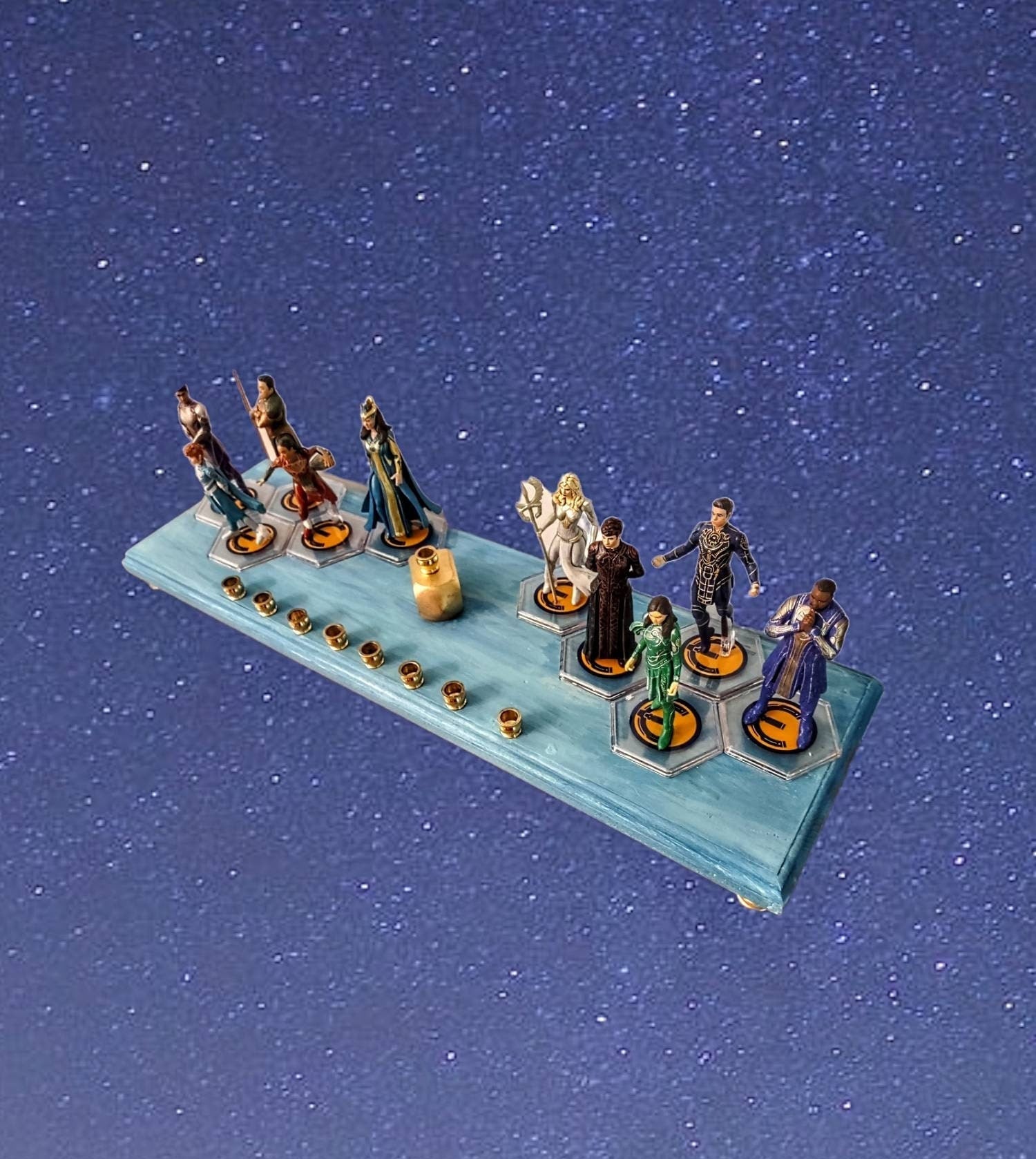 Eternals Menorah — row of superhero figures on a stained wood base with candle cups | Judaica Square Lakewood (view 3)