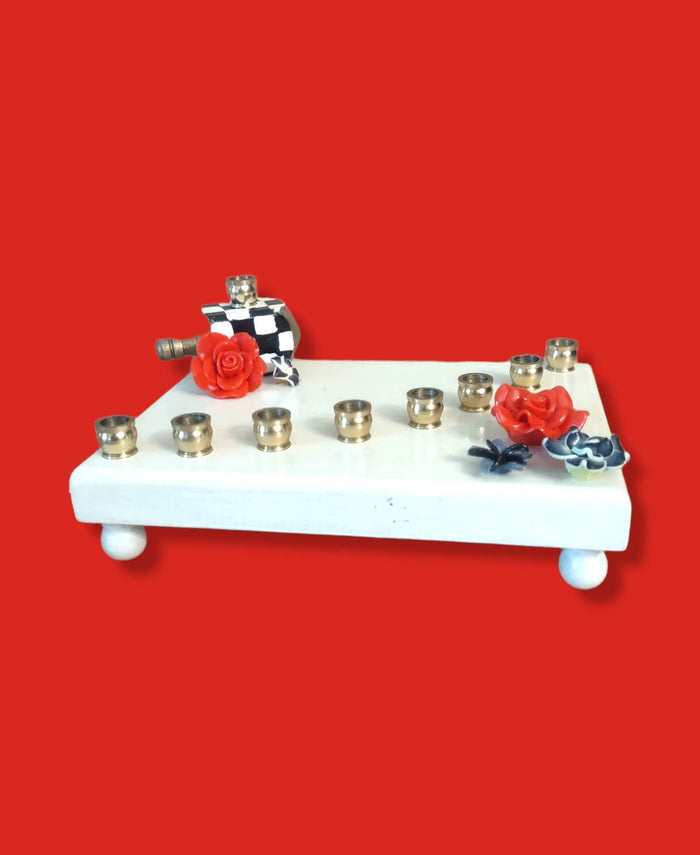 Checkerboard flower menorah — painted checks with red silicone blooms and brass cups | Judaica Square Lakewood