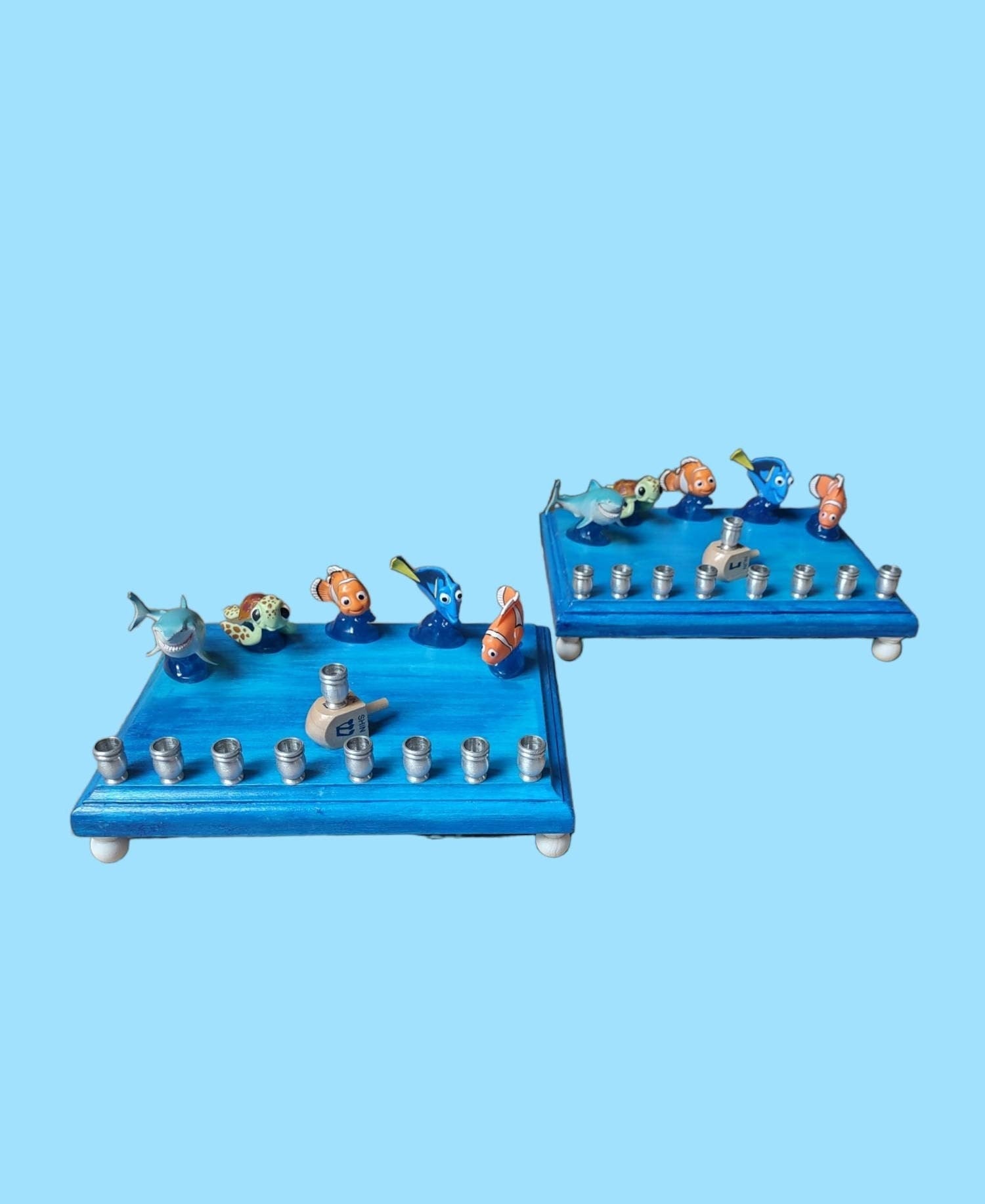 Finding Nemo Menorah — clownfish and blue tang figures on a painted plaque | Judaica Square Lakewood (view 2)