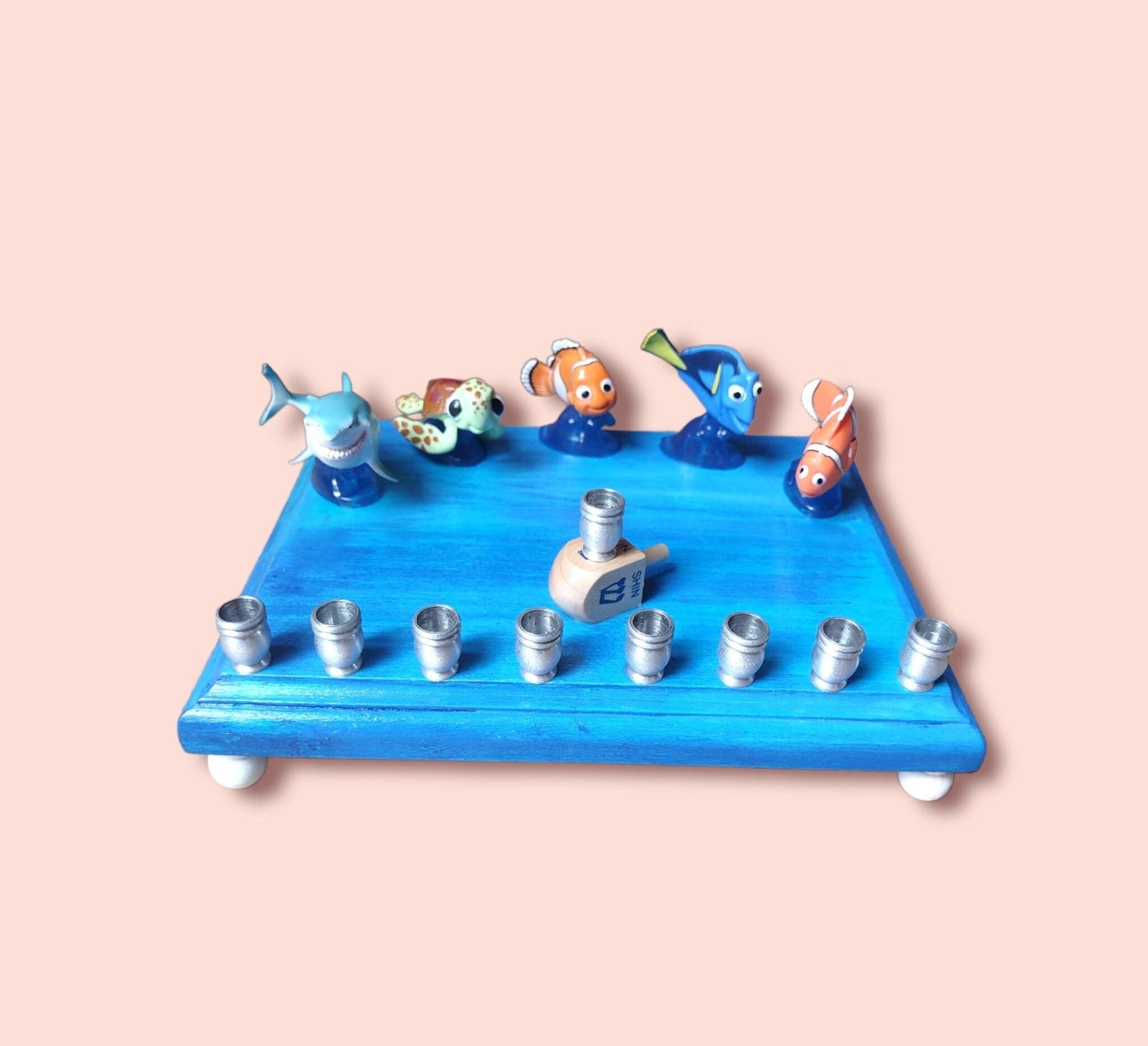 Finding Nemo Menorah — clownfish and blue tang figures on a painted plaque | Judaica Square Lakewood (view 3)