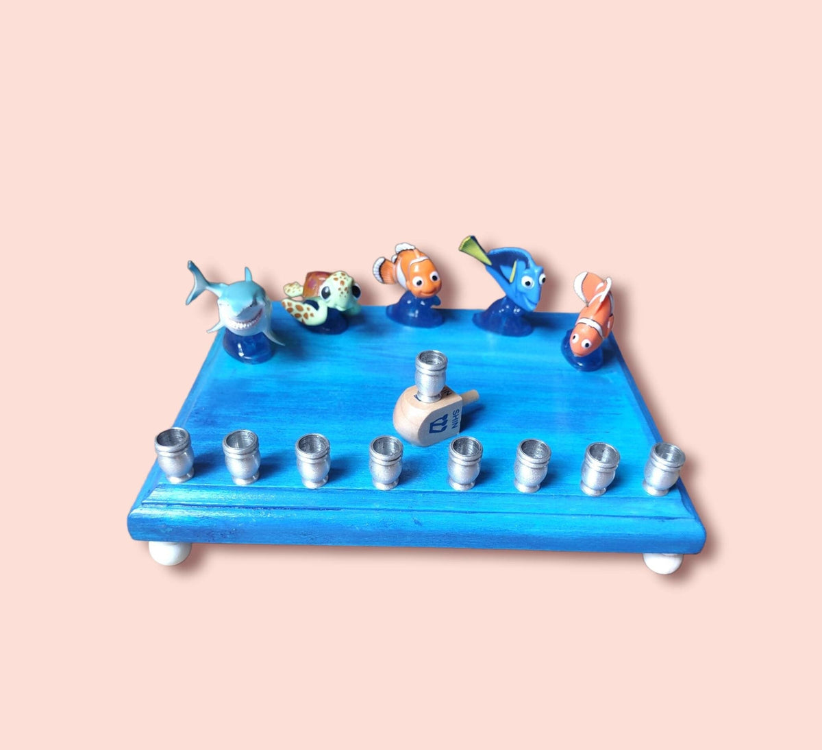 Finding Nemo Menorah — clownfish and blue tang figures on a painted plaque | Judaica Square Lakewood (view 3)
