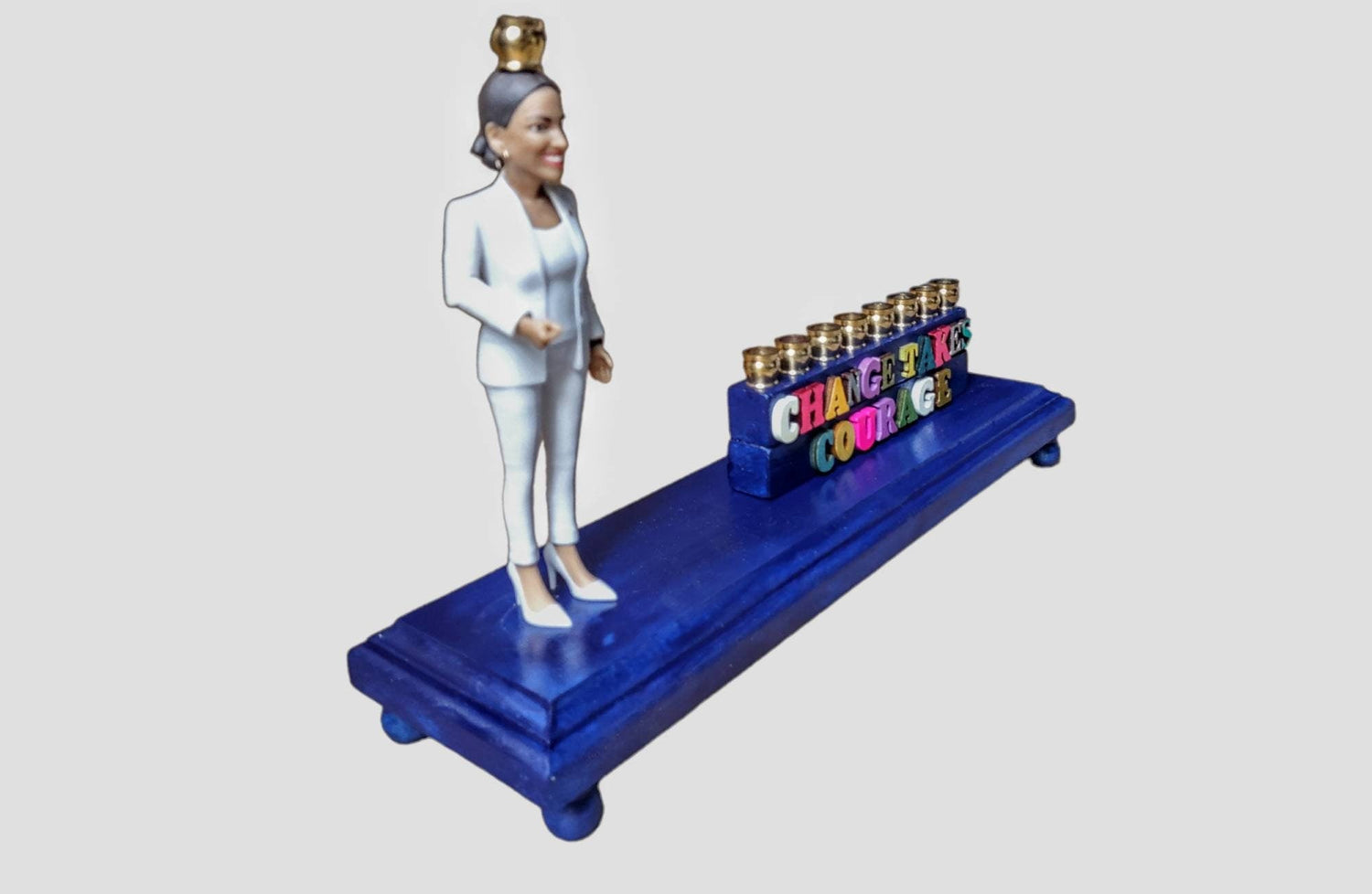 Senator AOC menorah — action figure raising the shamash beside carved wood letters | Judaica Square Lakewood (view 3)