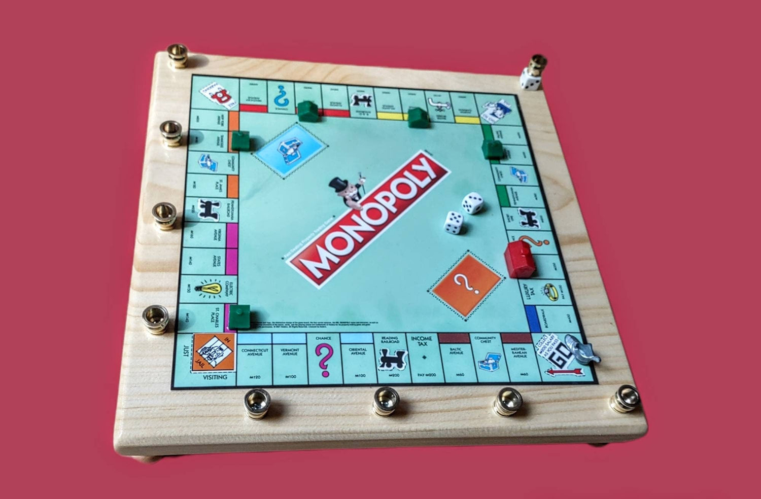 Monopoly menorah — repurposed game board and tokens on stained wood with brass cups | Judaica Square Lakewood (view 3)