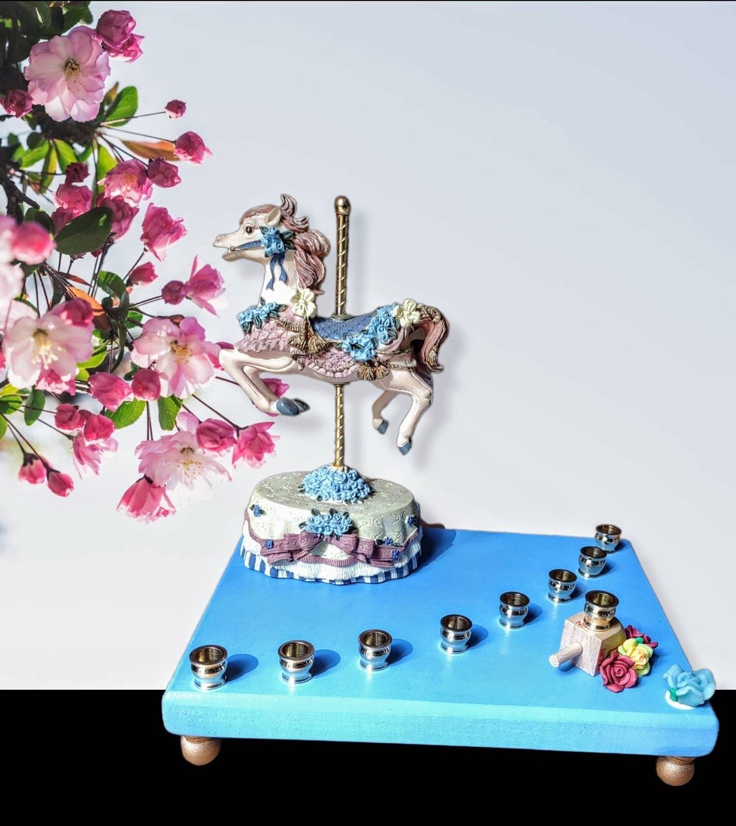 Carousel menorah — vintage musical horse on painted base with silicone flowers | Judaica Square Lakewood (view 2)