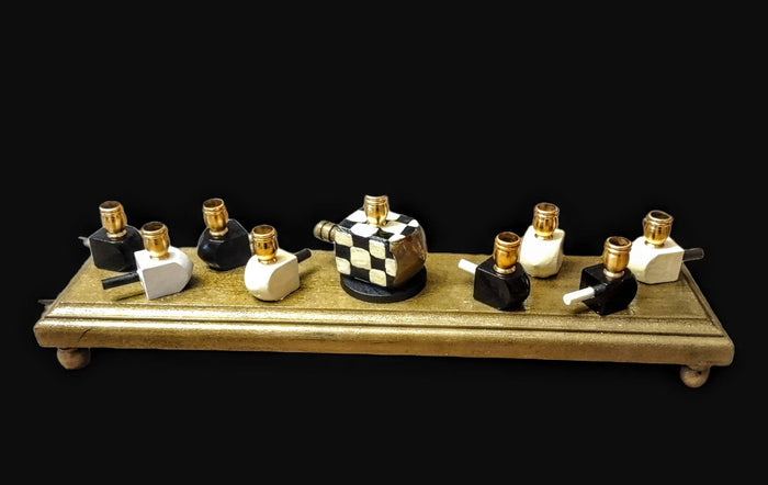 Checkerboard dreidel menorah — black and white checked wood dreidels with gold cups | Judaica Square Lakewood