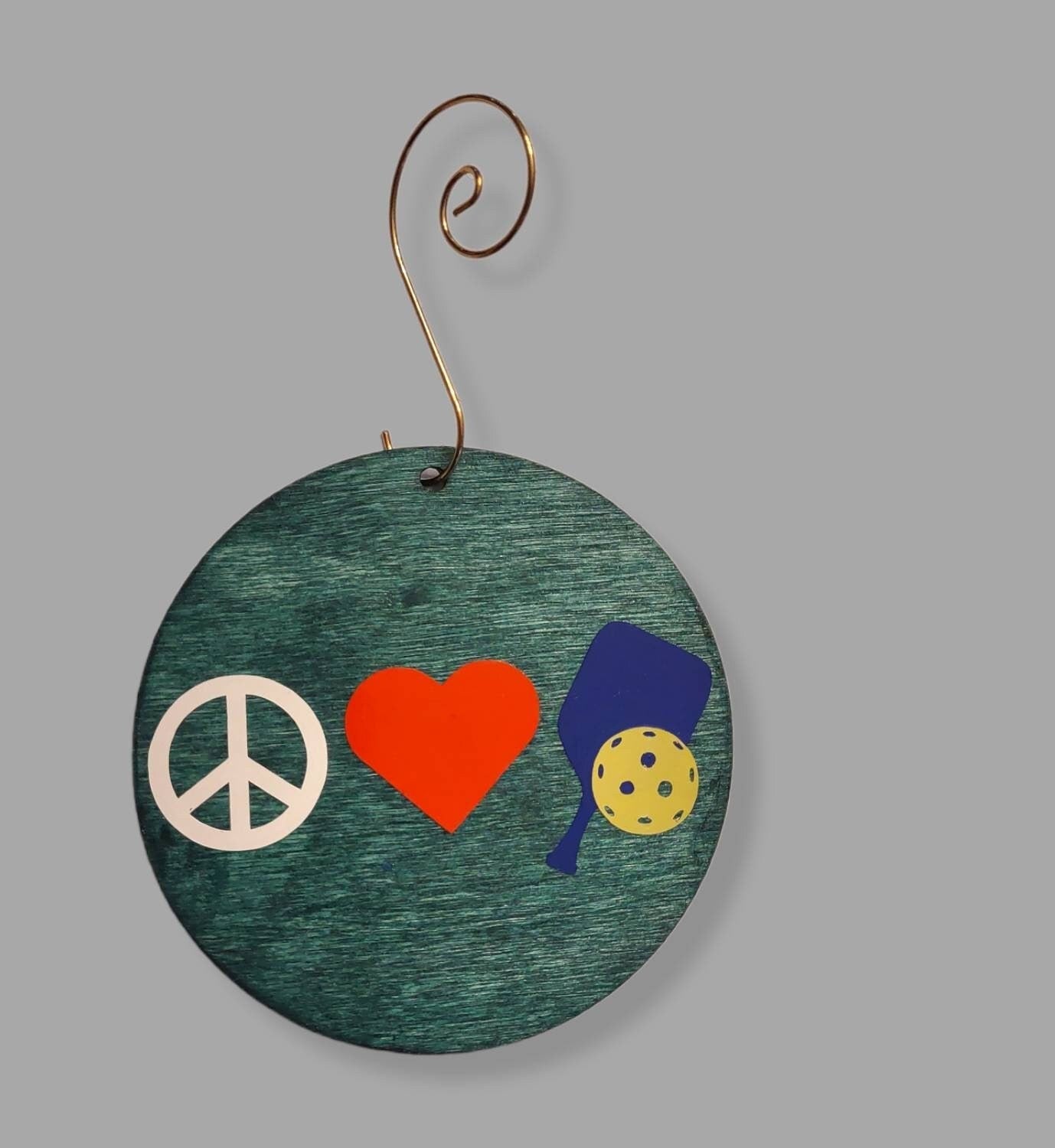 Pickleball ornament — green-stained wood circle with white pickleball decal and hook | Judaica Square Lakewood (view 2)