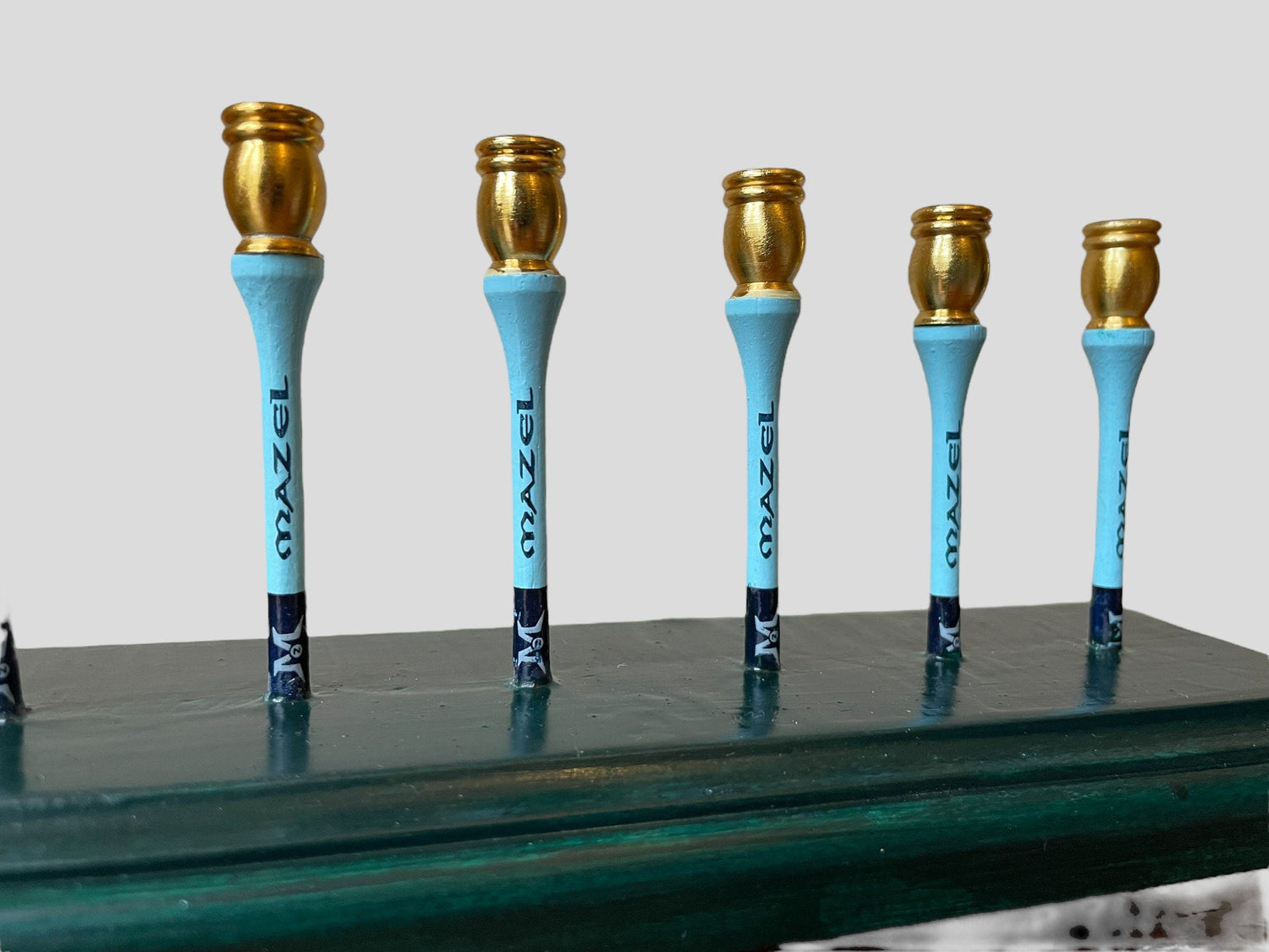 Golf Tee Time Menorah — green base with wooden tees, golf ball and gold cups | Judaica Square Lakewood (view 3)