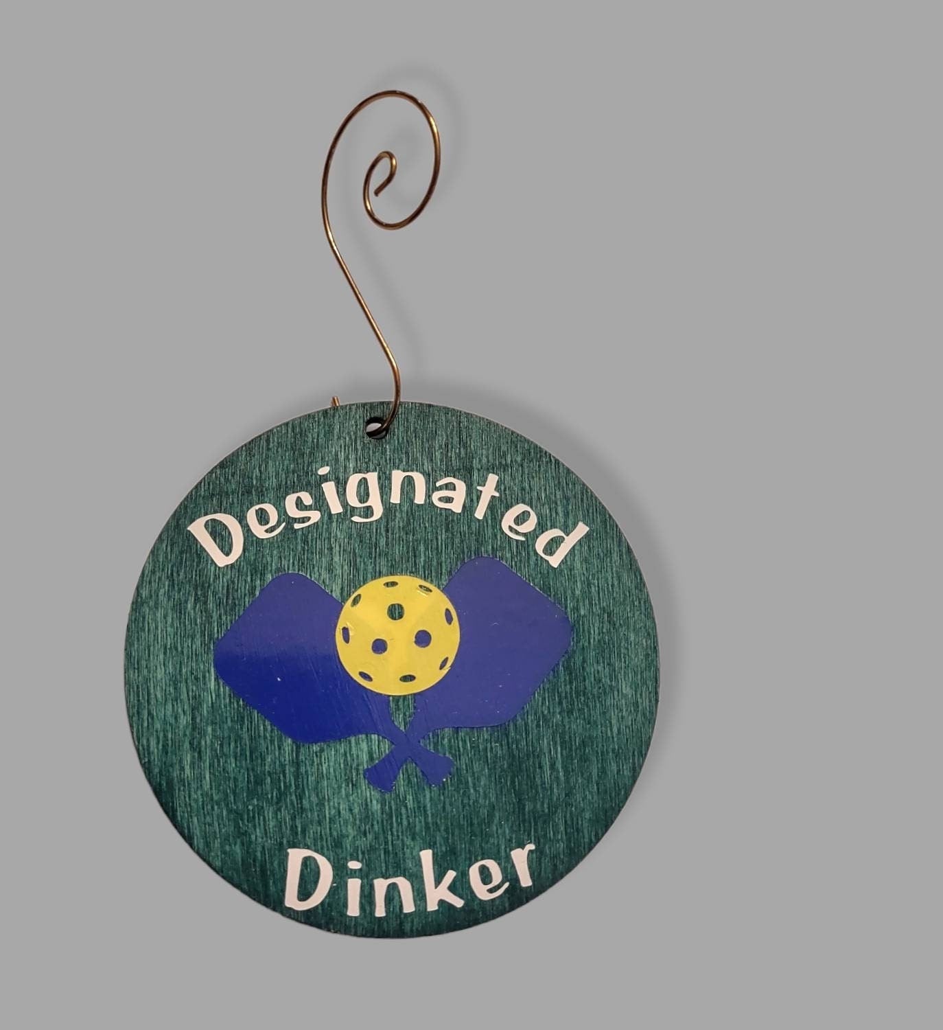 Pickleball ornament — green-stained wood circle with white pickleball decal and hook | Judaica Square Lakewood (view 3)