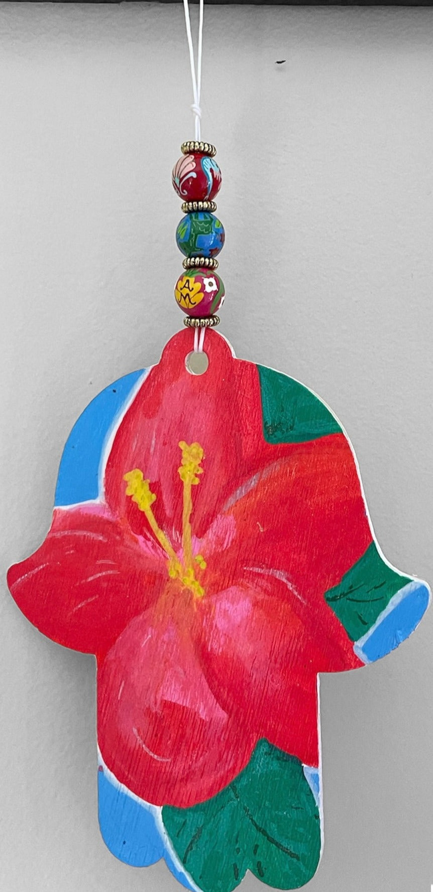 Hibiscus hamsa — painted wood hand on cotton string with wooden beads | Judaica Square Lakewood (view 4)