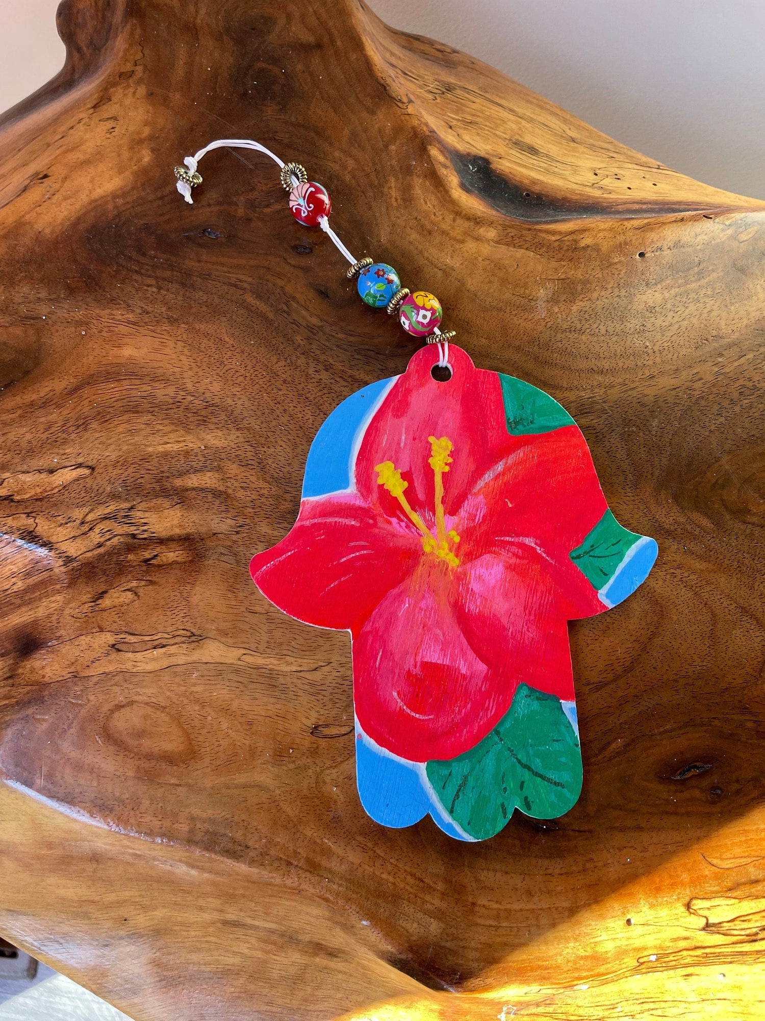 Hibiscus hamsa — painted wood hand on cotton string with wooden beads | Judaica Square Lakewood (view 2)