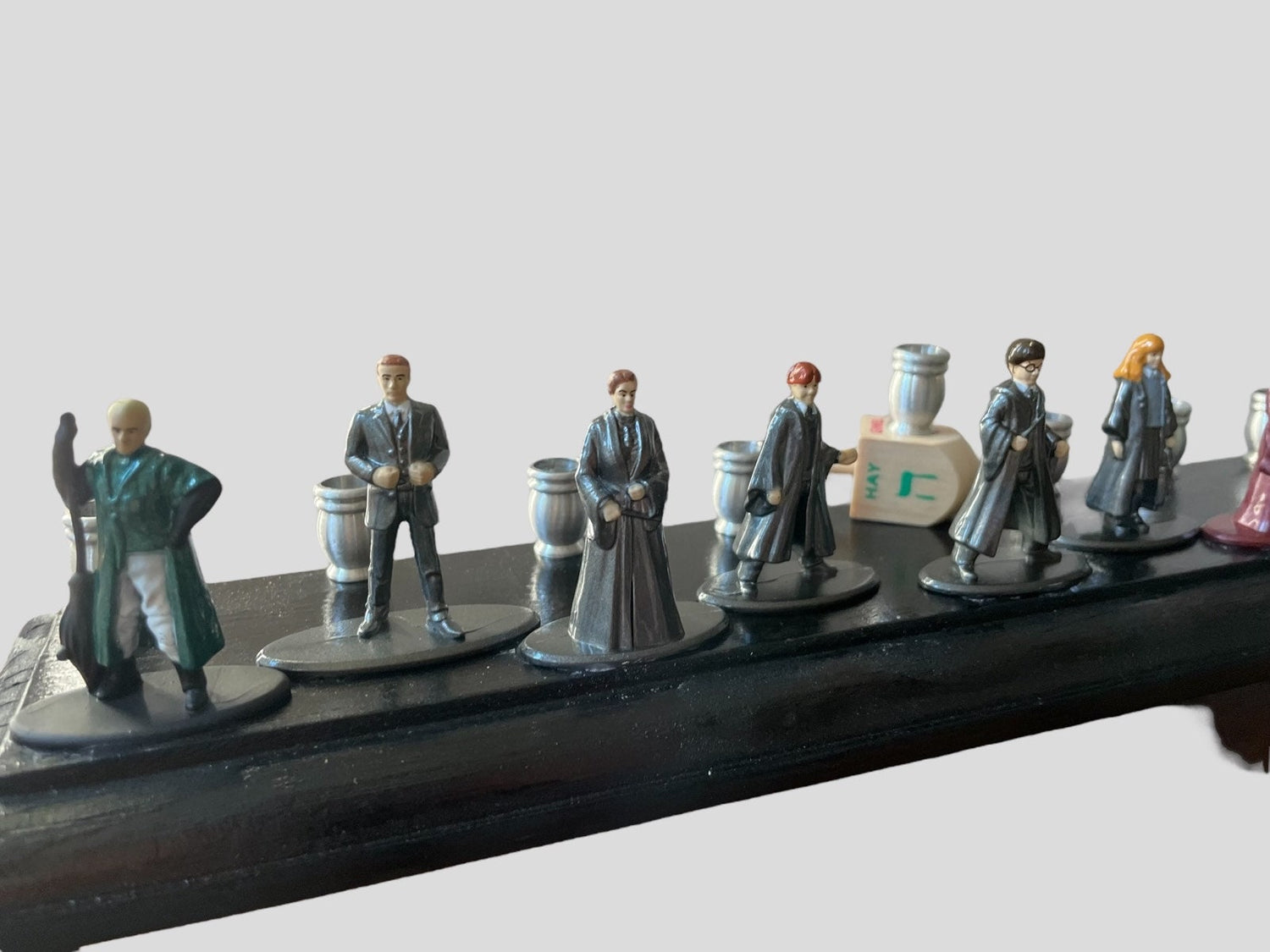 Harry Potter Collector Menorah — nine wizard figures on a long wood plaque | Judaica Square Lakewood (view 4)