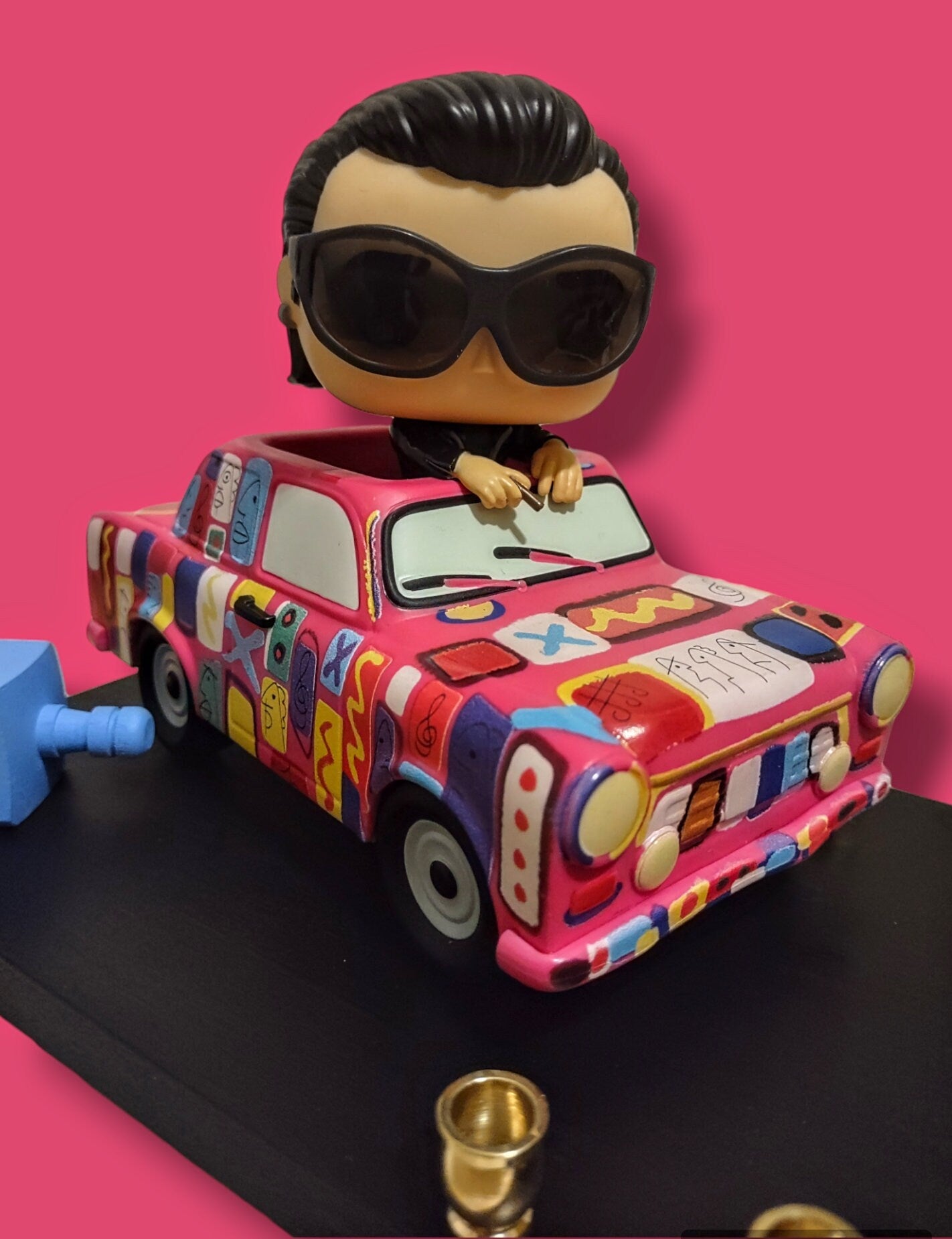 U2 Bono menorah — vinyl Bono figure in the painted Achtung Baby car with brass candle cups | Judaica Square Lakewood (view 2)