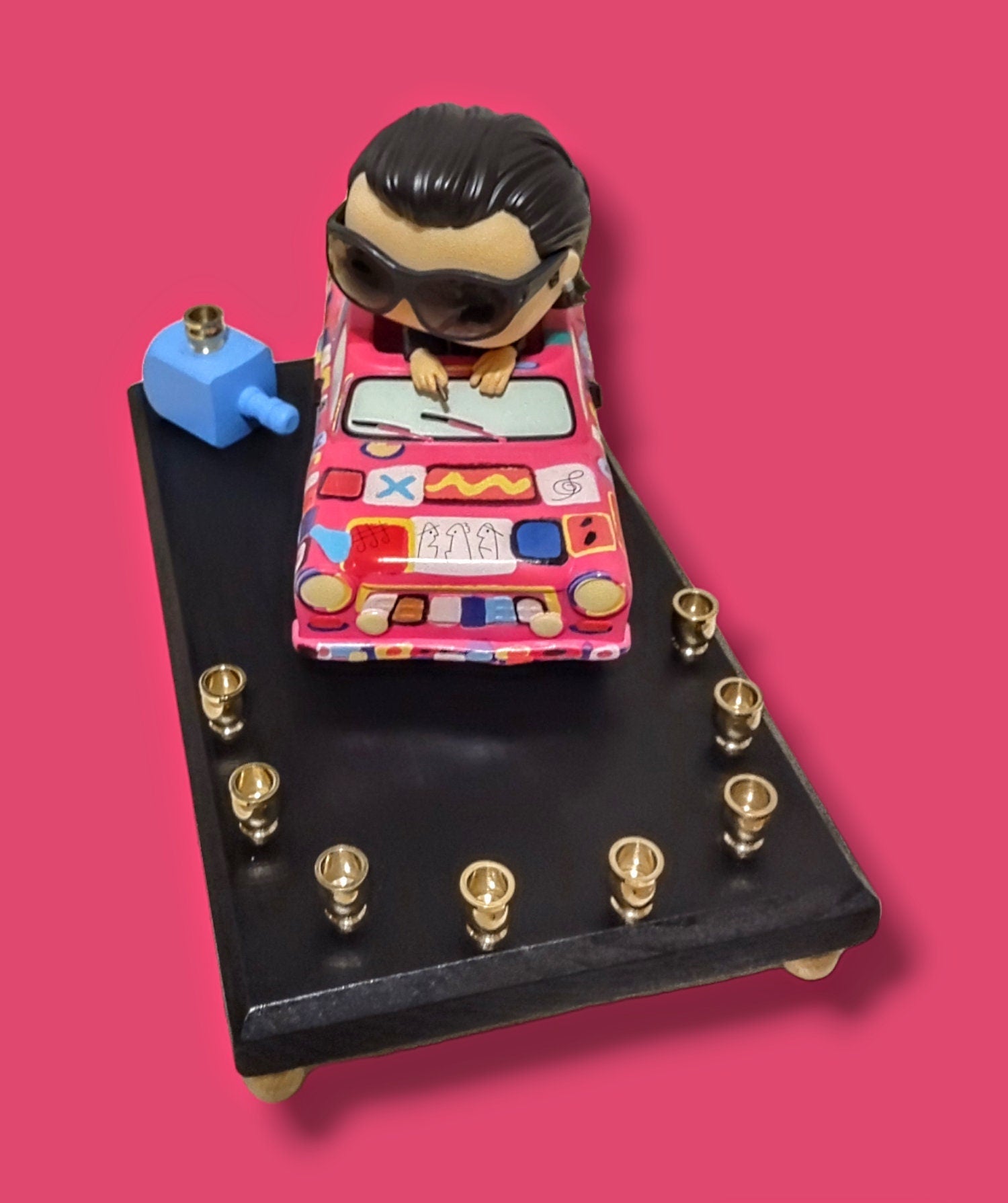 U2 Bono menorah — vinyl Bono figure in the painted Achtung Baby car with brass candle cups | Judaica Square Lakewood (view 3)