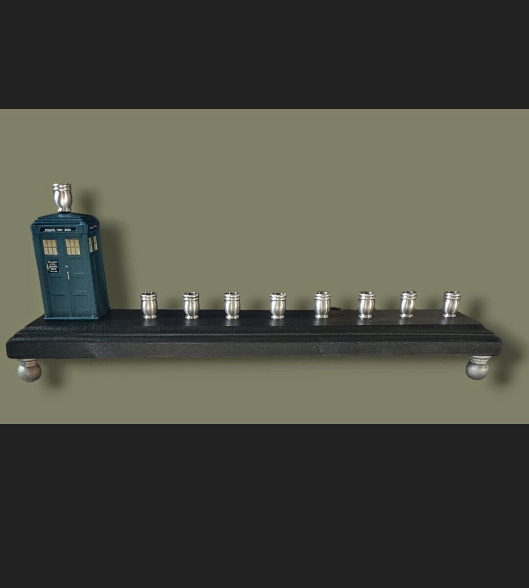 Doctor Who TARDIS menorah — blue police box collectible above brass candle cups | Judaica Square Lakewood (view 5)