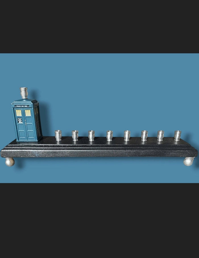 Doctor Who TARDIS menorah — blue police box collectible above brass candle cups | Judaica Square Lakewood
