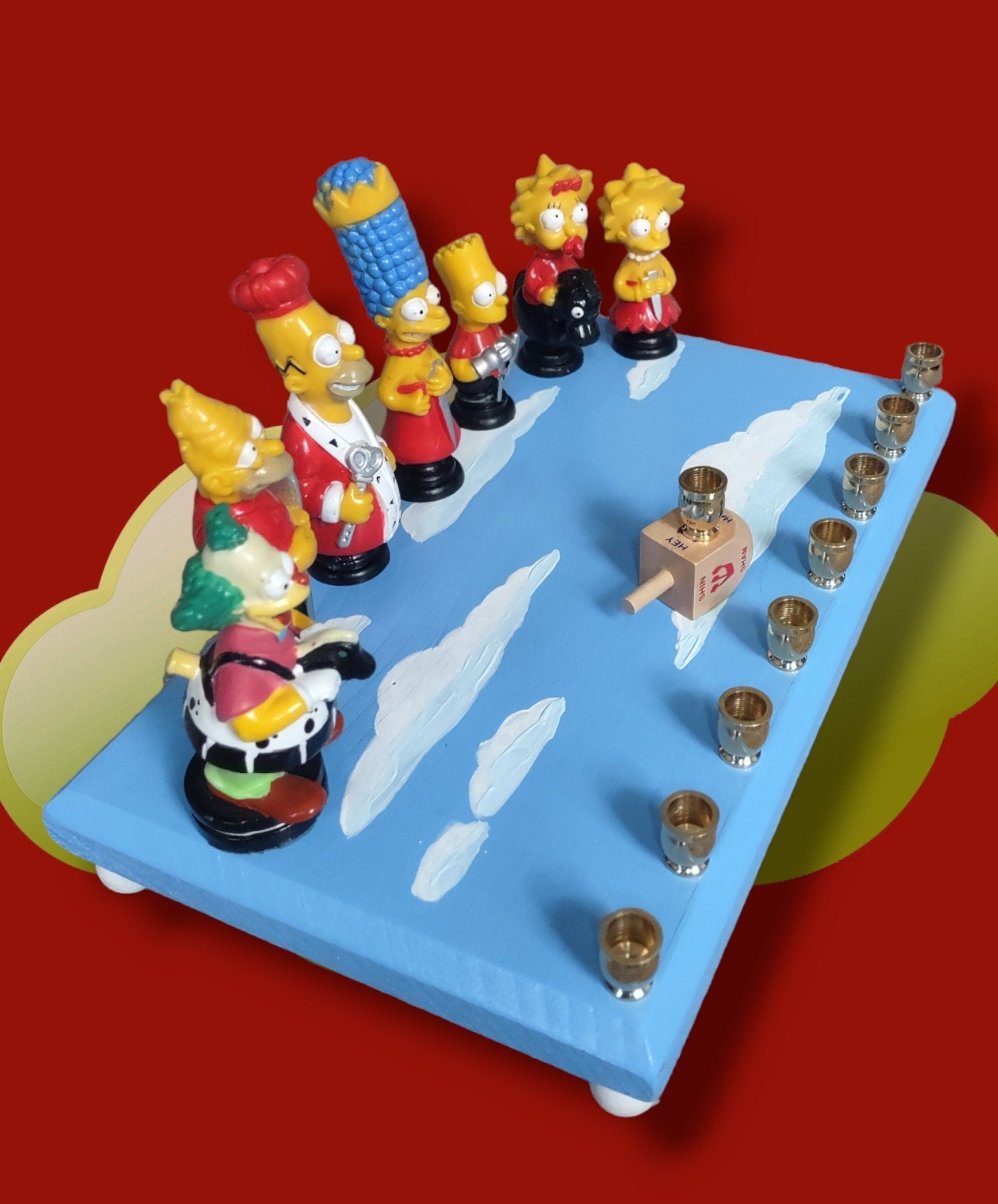 Simpsons Menorah — Homer and family chess figures on a wood plaque | Judaica Square Lakewood (view 3)