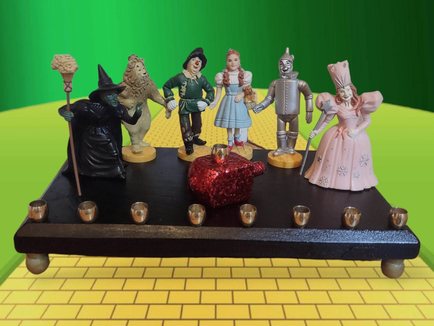 Wizard of Oz menorah — glittered repurposed figures beside a ruby red wood dreidel | Judaica Square Lakewood (view 4)