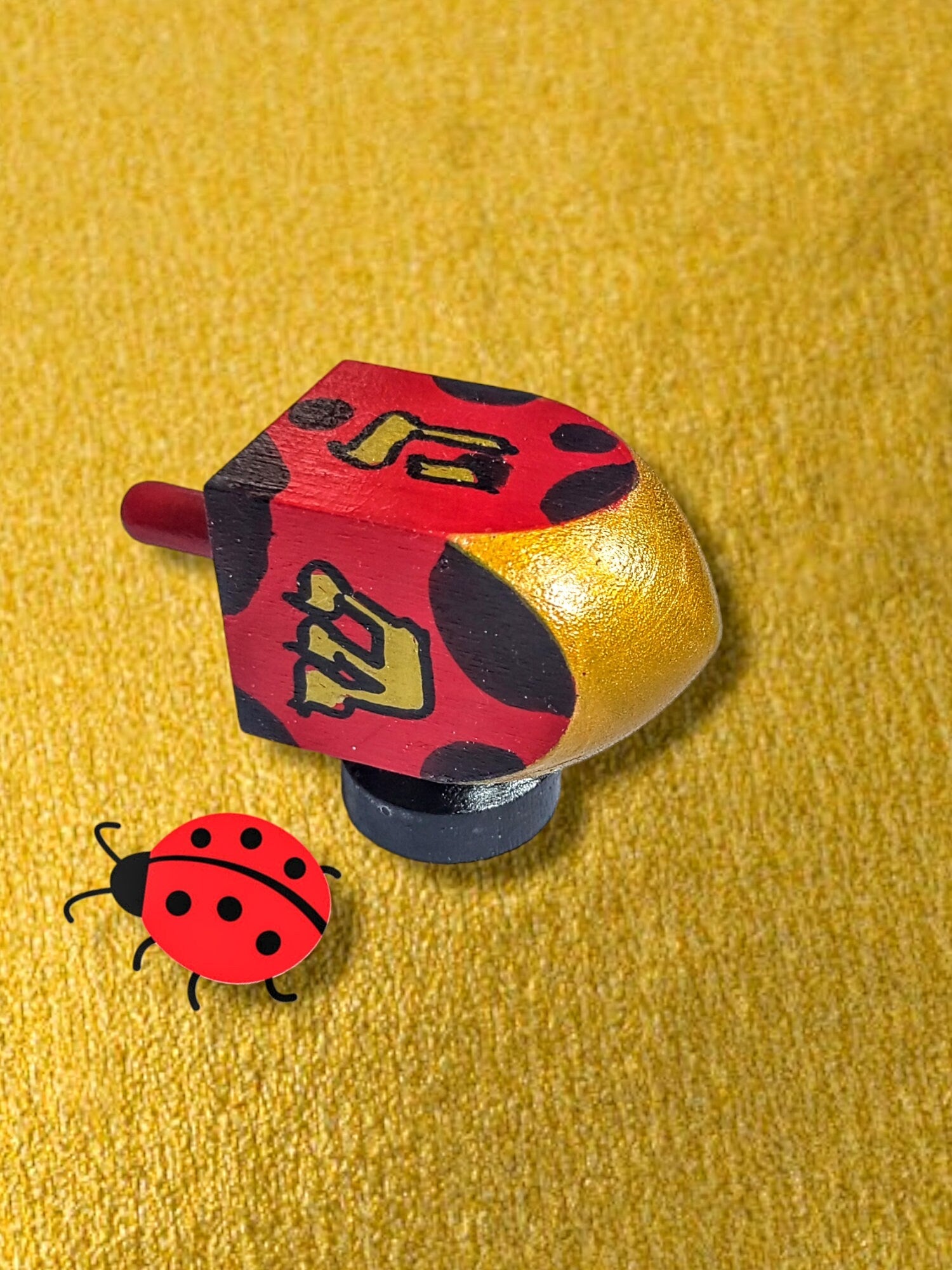 Hand-Painted Ladybug Dreidel — wood dreidel with ladybug art on stand | Judaica Square Lakewood (view 3)