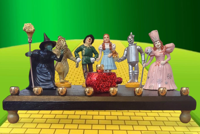 Wizard of Oz menorah — glittered repurposed figures beside a ruby red wood dreidel | Judaica Square Lakewood