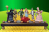 Wizard of Oz menorah — glittered repurposed figures beside a ruby red wood dreidel | Judaica Square Lakewood