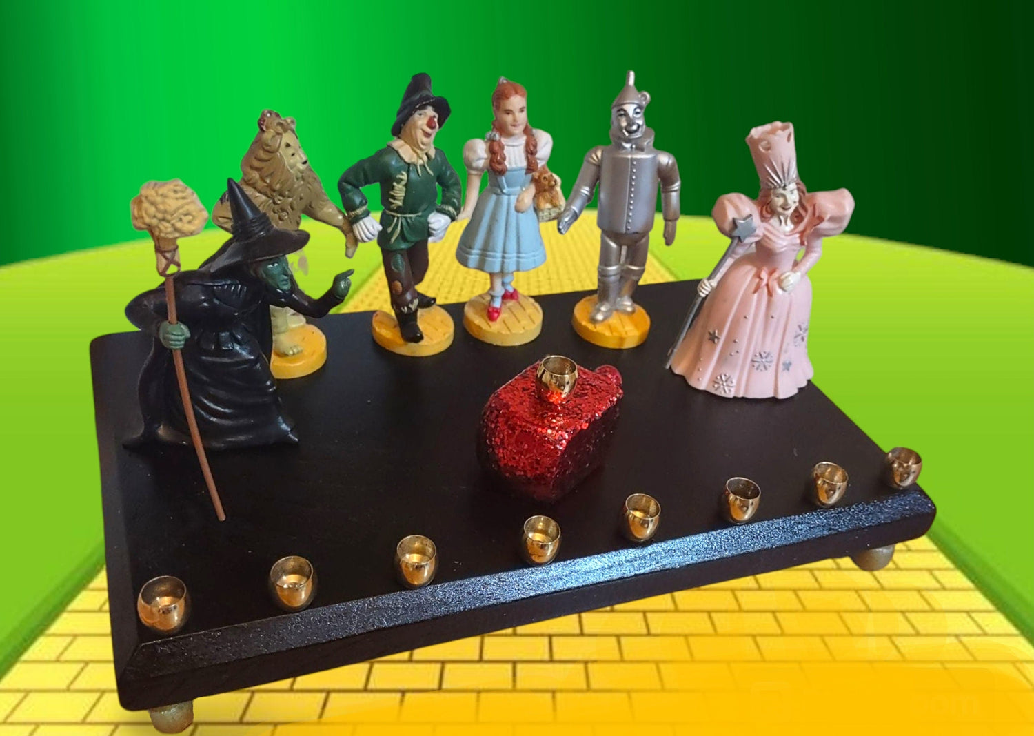 Wizard of Oz menorah — glittered repurposed figures beside a ruby red wood dreidel | Judaica Square Lakewood (view 2)