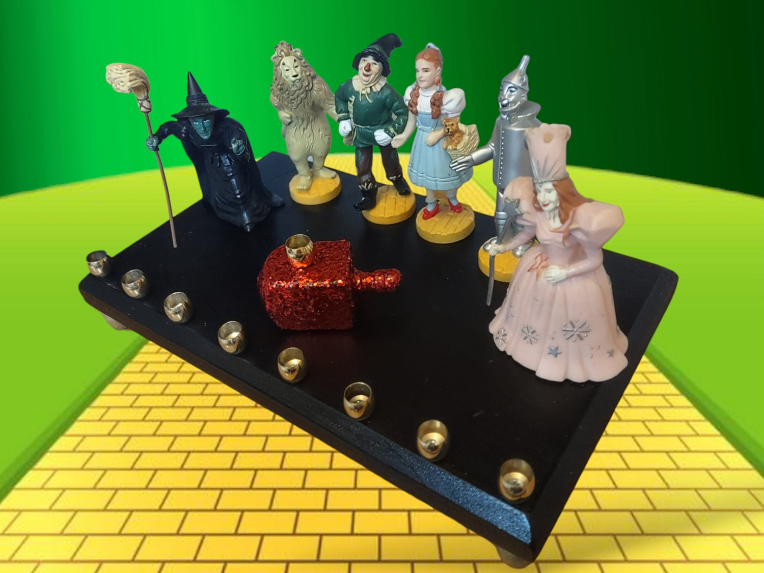 Wizard of Oz menorah — glittered repurposed figures beside a ruby red wood dreidel | Judaica Square Lakewood (view 3)