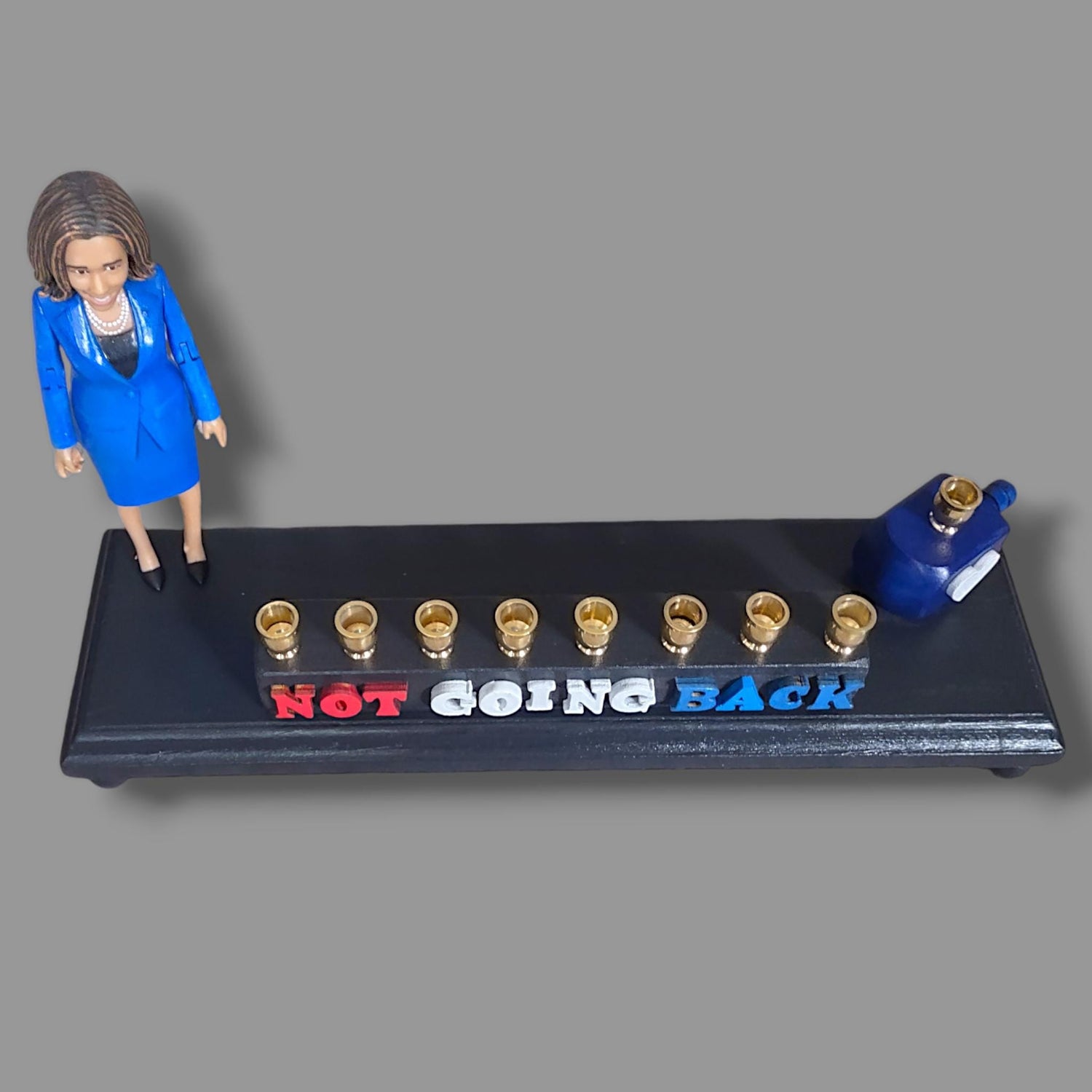 Not Going Back Menorah — Harris figure on painted base with nickel cups | Judaica Square Lakewood (view 3)