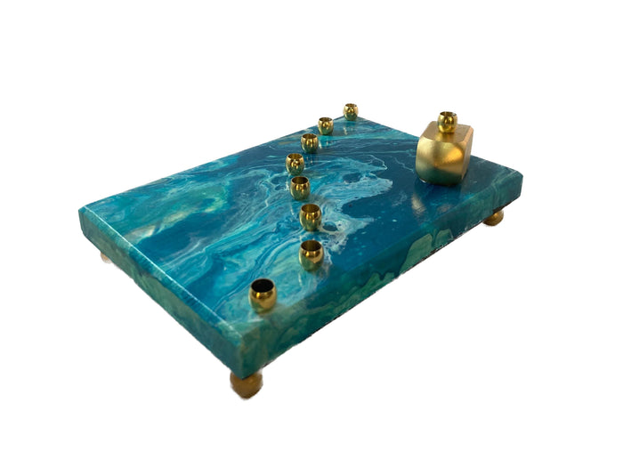 Paint pour menorah — teal and turquoise poured acrylic base with brass candle cups | Judaica Square Lakewood