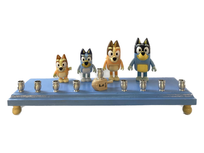 Bluey menorah — blue cartoon dog figures on wood base with brass candle cups | Judaica Square Lakewood