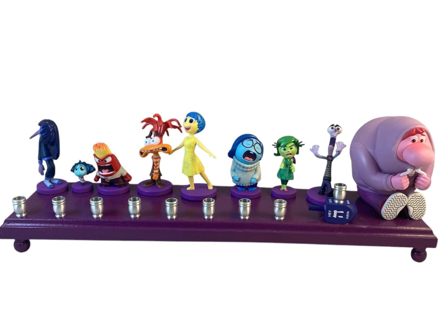 Inside Out 2 Menorah — colorful emotion figures along a long wood plaque | Judaica Square Lakewood (view 2)