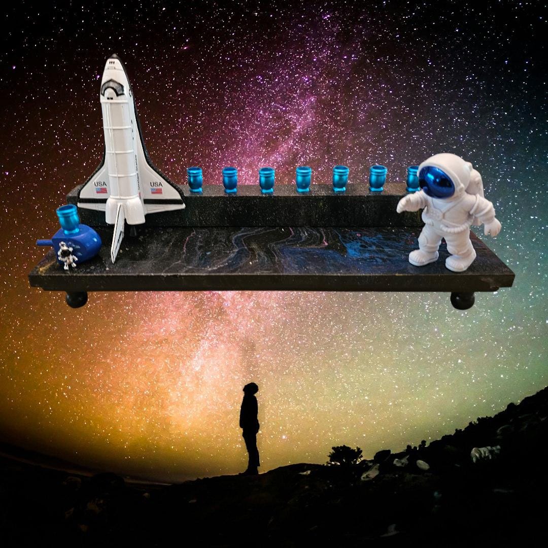 Outer space menorah — die-cast rocketship and astronaut on paint-poured base | Judaica Square Lakewood (view 2)