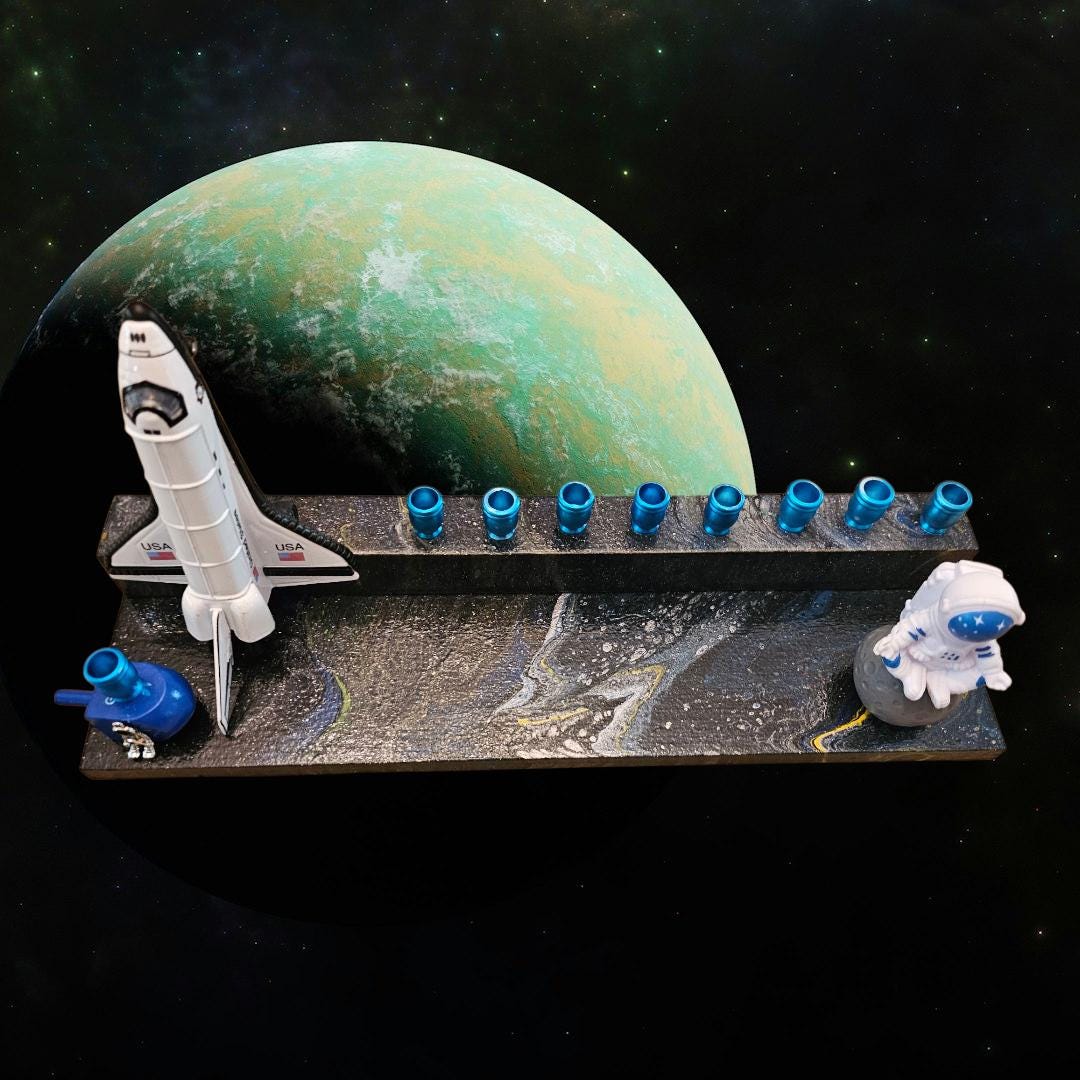 Outer space menorah — die-cast rocketship and astronaut on paint-poured base | Judaica Square Lakewood (view 3)