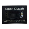 Black comb-style snap kippah clip mounted on a black card printed Keep-Kippah