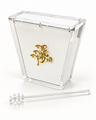 Clear acrylic Apex Collection honey box standing upright, hinged lid closed, raised gold Hebrew emblem on the white front panel, with a clear acrylic honey dipper lying in front
