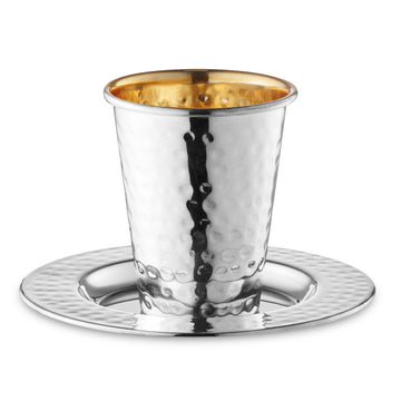 Hammered silver-coated Kiddush cup with gold-tone interior on a matching hammered-rim plate