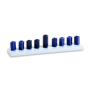Strip menorah with pale enamel base and nine glossy deep-blue square cups, centre shamash raised