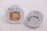 Stack of silver-colour plastic mini trays in a labelled bag beside one loose scalloped tray