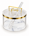 Round clear acrylic honey dish with a gold band at the rim and a white marbled base, lid closed with a raised gold cursive Hebrew handle and a clear acrylic dipper resting across it