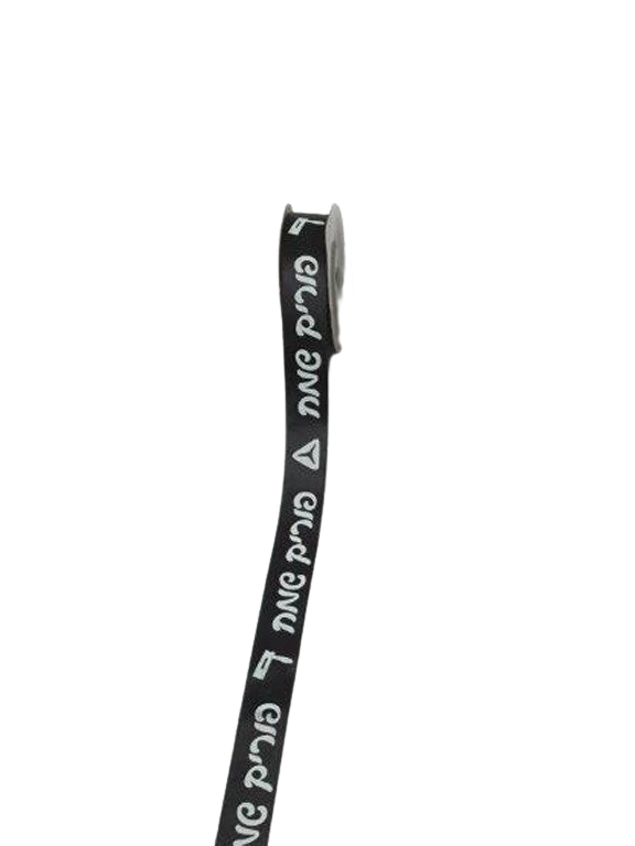 Roll of black ribbon printed in white with repeating Hebrew Purim Sameach and small Purim icons