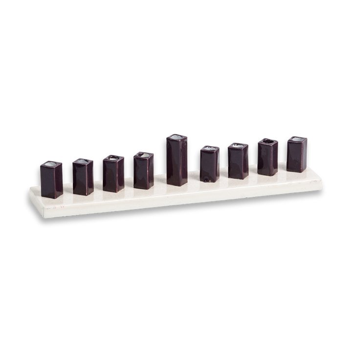 Strip menorah with pearl-white enamel base and nine glossy dark square cups, centre shamash raised