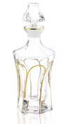 Clear glass wine decanter with gold arch lines on paneled sides, gold neck band and faceted stopper