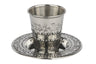 Stainless steel kiddush cup with etched pomegranate branches on a matching decorated plate