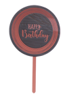 Round cake topper on pink stick with rose-pink Happy Birthday script and rings on dark center