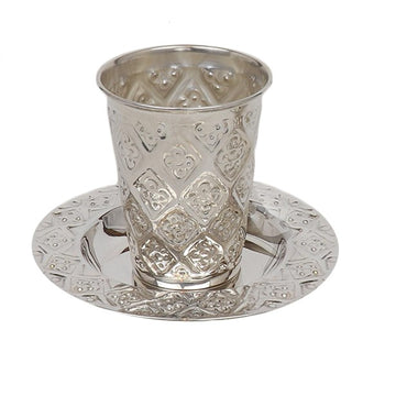 Silver-coated Kiddush cup with raised diamond floral panels on a matching diamond-pattern plate